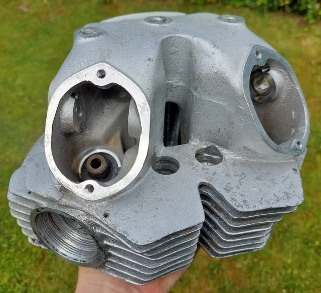 Blasting a cylinder head with fine grit. Access Norton