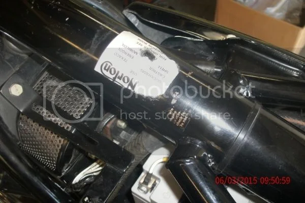 Placement of oil use decal under gas tank