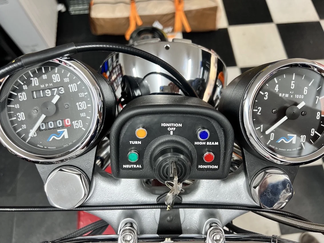 Speedo and Tach cables fouling the headlamp ears? Access Norton
