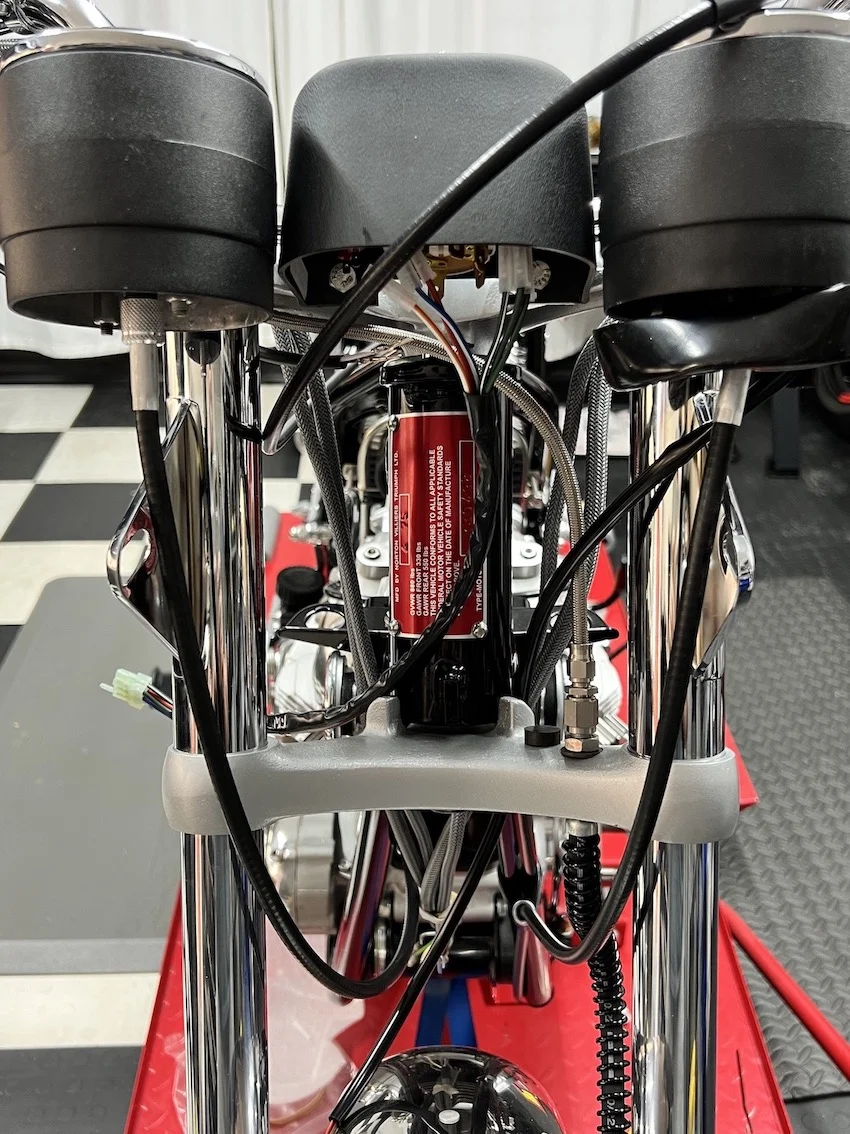 Speedo and Tach cables fouling the headlamp ears? Access Norton